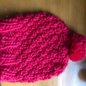 Pink crocheted beanie hat with Pom Pom on top.